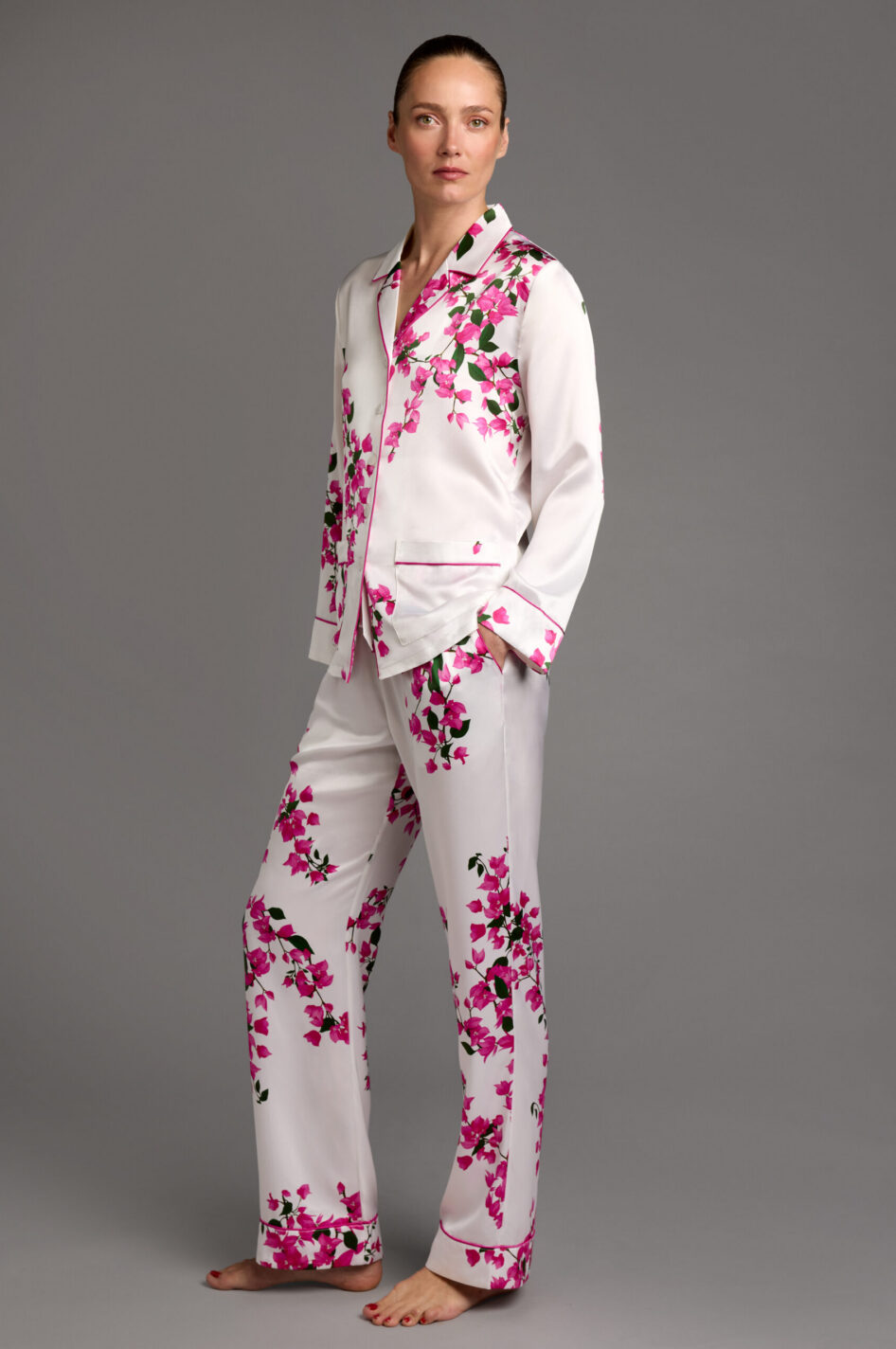 View of floral silk pyjamas showing full-length bougainvillea print design